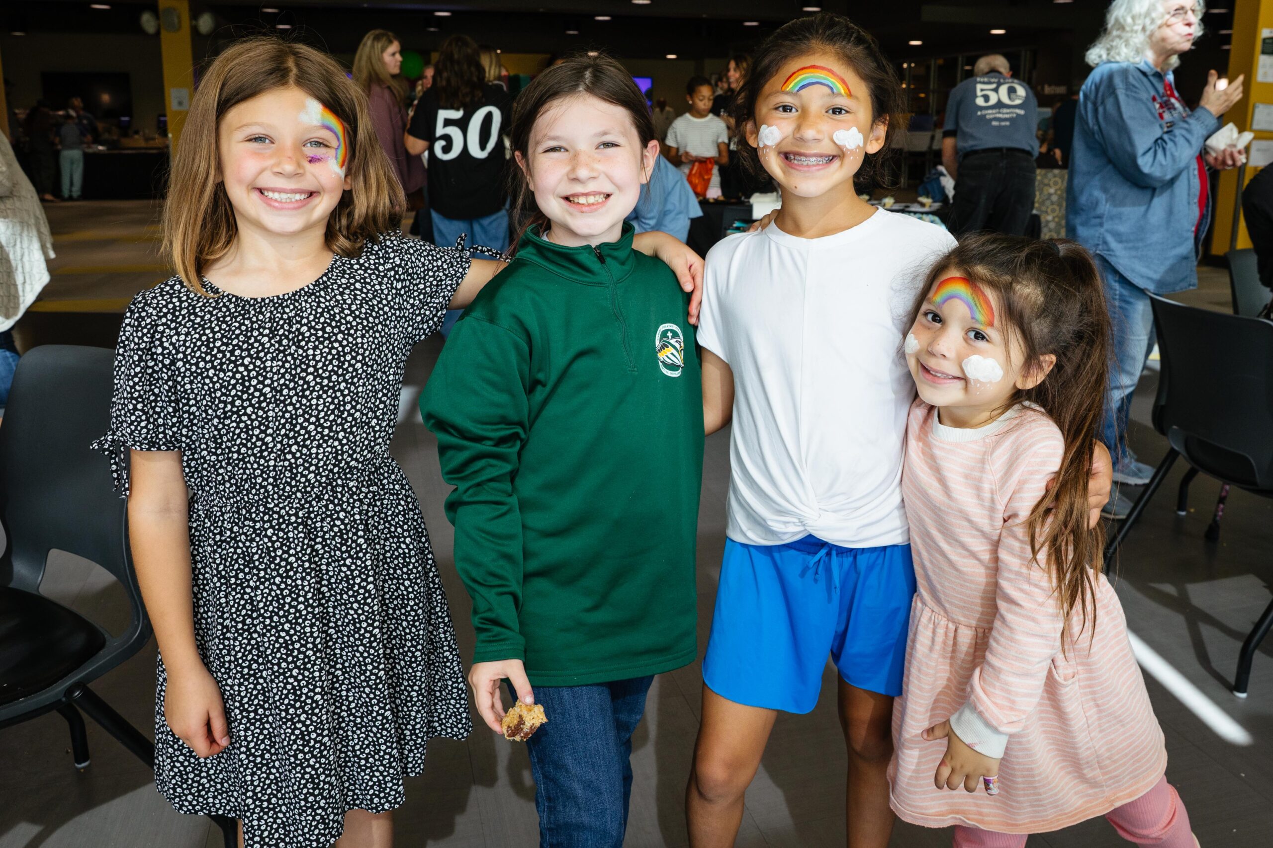 Children enjoying face painting at New Life’s 50th Birthday Bash