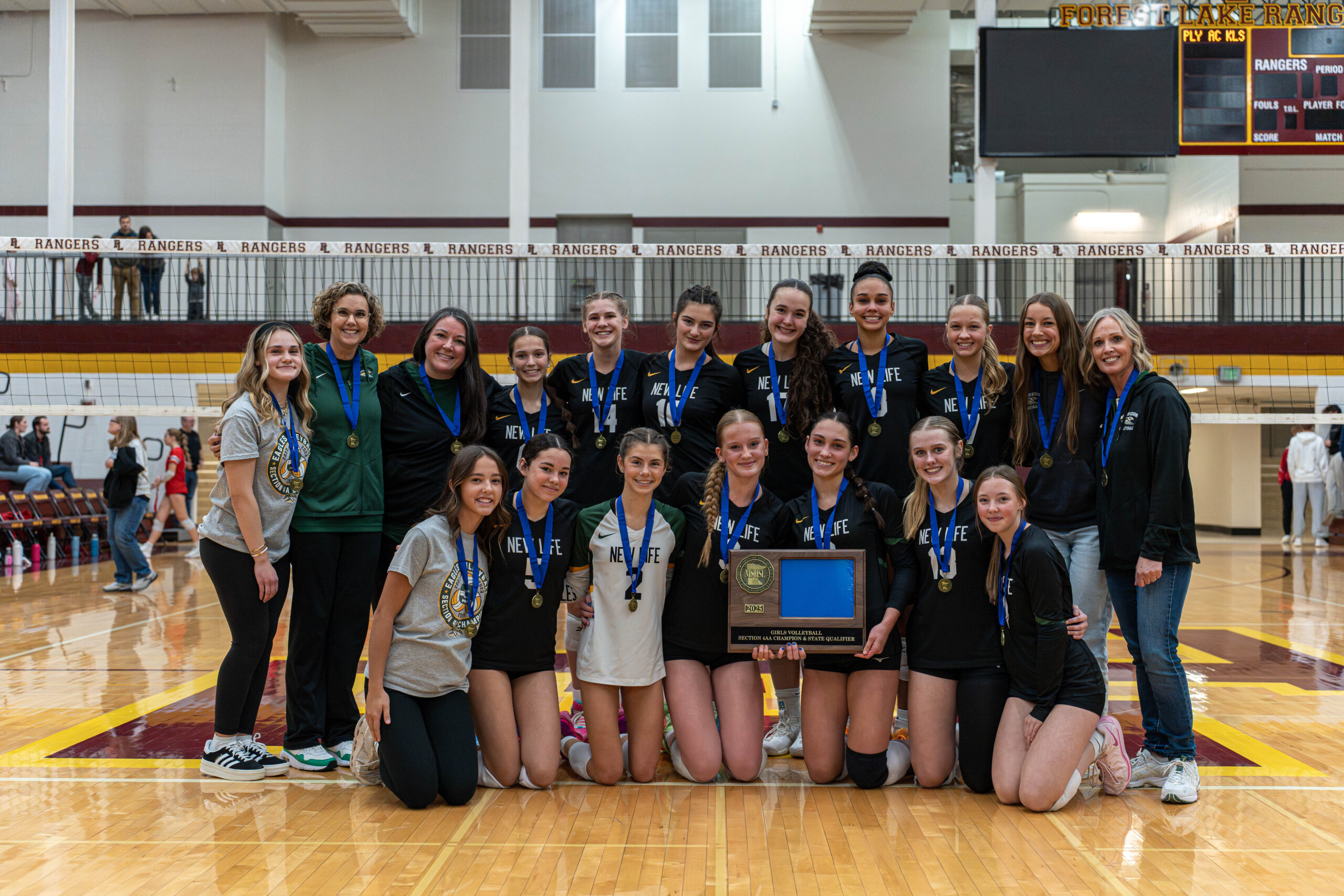 The NLA Girls Varsity Volleyball Team poses together after winning the Section 4AA Championship