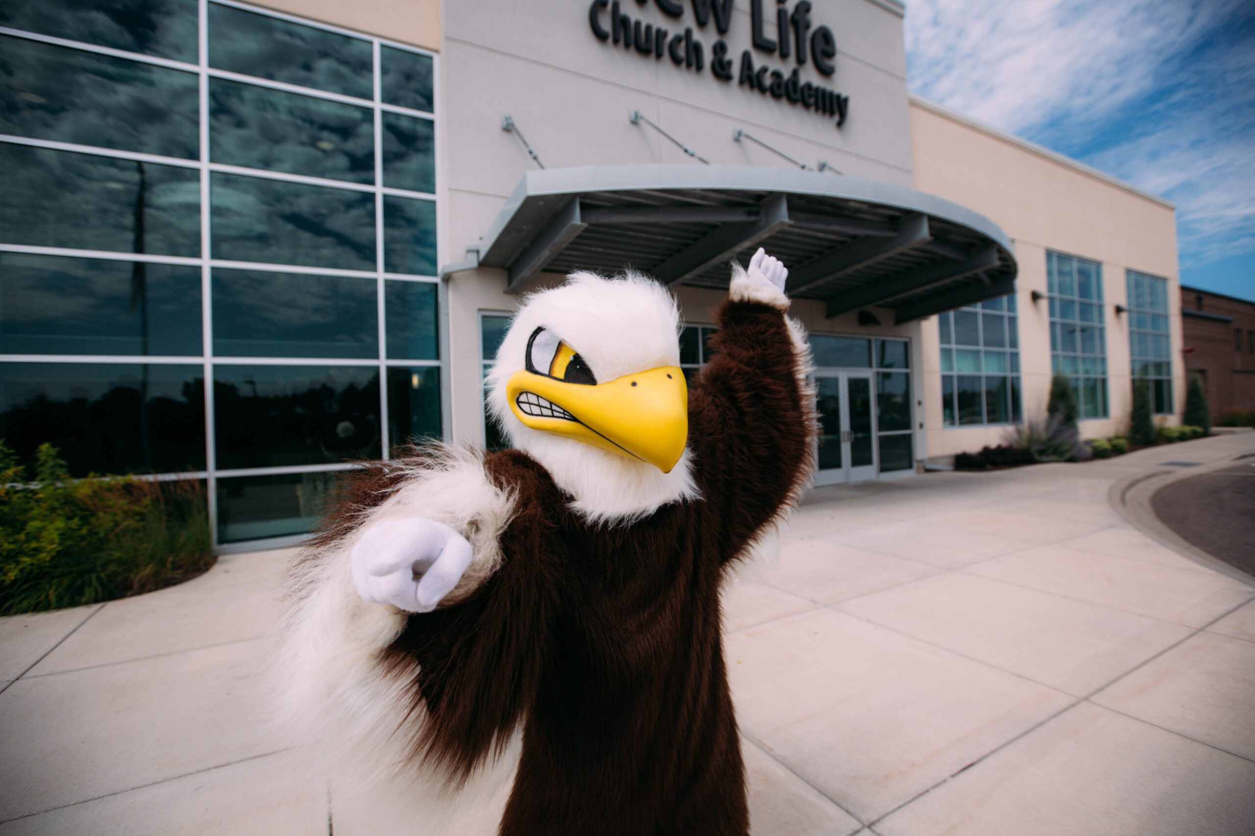Soarin, the New Life Academy Eagles mascot, welcomes students and families outside the New Life Church & Academy campus in Woodbury, Minnesota.