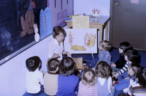 Teacher Sharon Strom leads one of New Life Christian School's first preschool classes with students gathered for a Bible lesson.