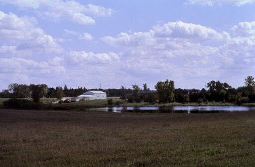 Historic view of the 22 acre Woodbury property purchased by New Life in 1978, including the pond and original buildings.
